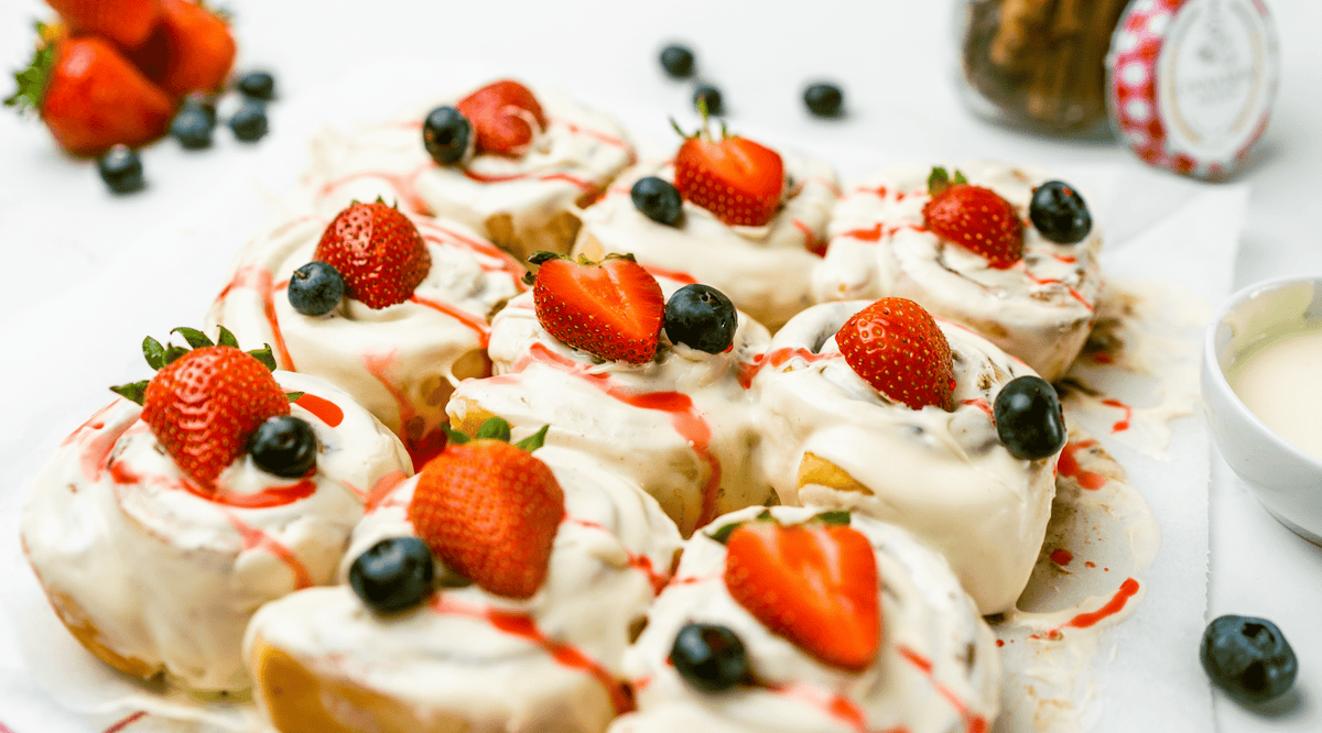 Cinnamon scrolls topped with fresh strawberries and blueberries